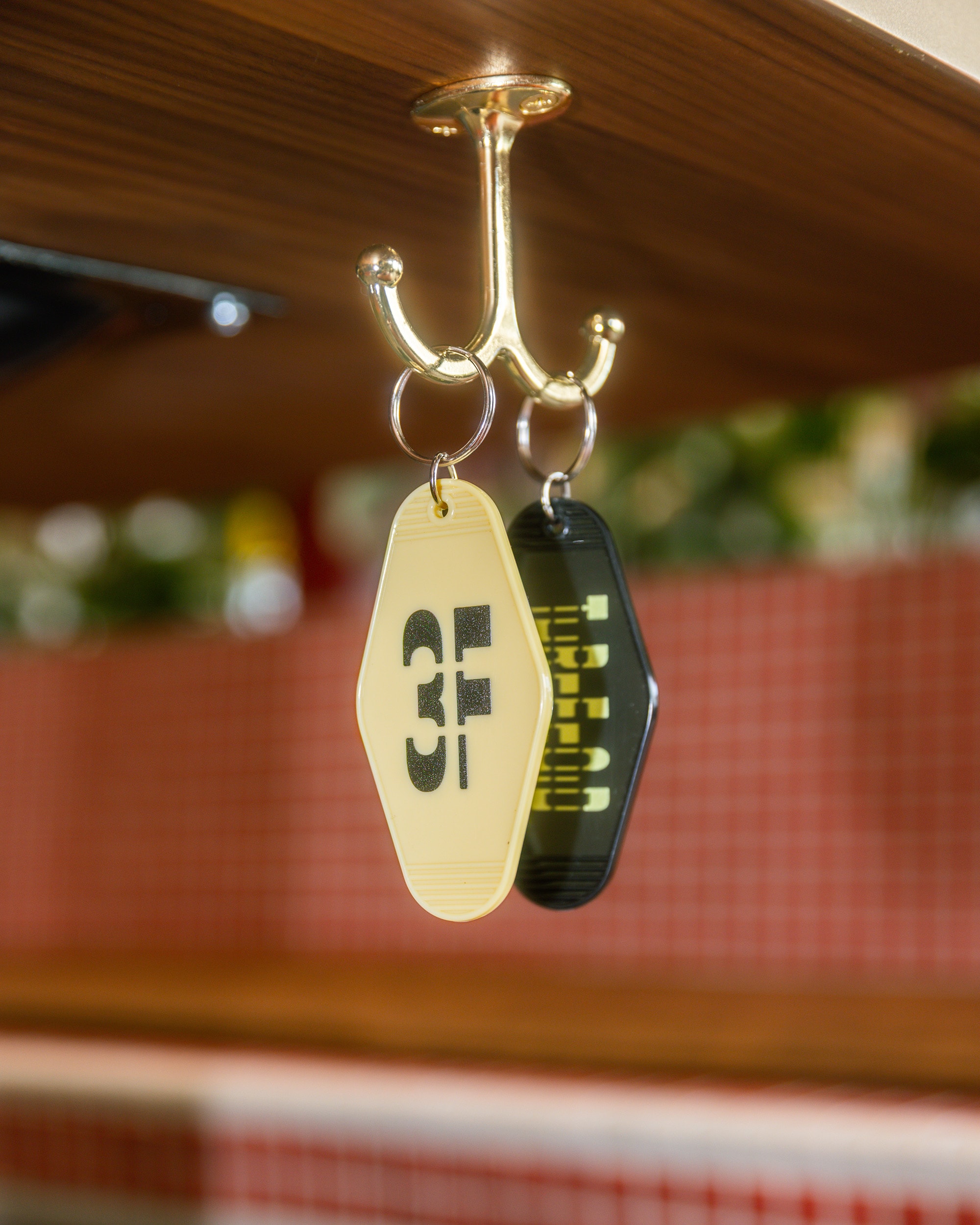 Threefold keychains hanging from a table